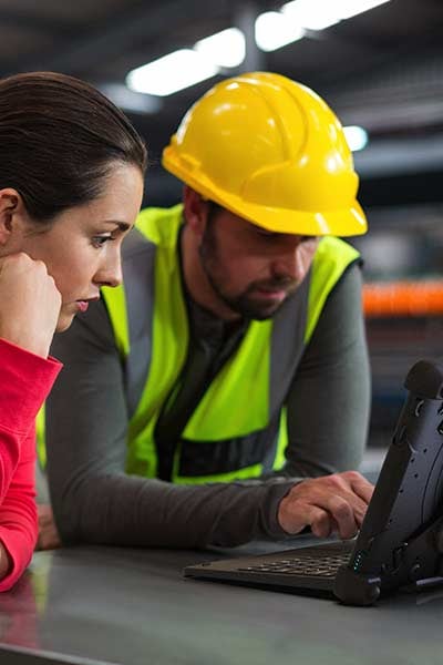 A man and a woman use a Flex 10B Rugged Tablet