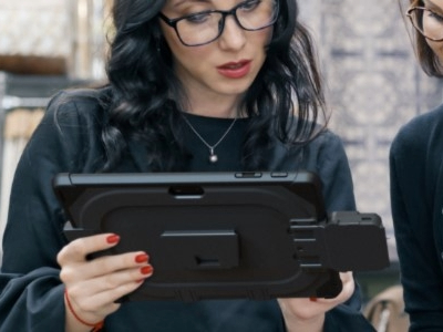 woman holding rugged tablet from mobiledemand with integrated payment device from magtek