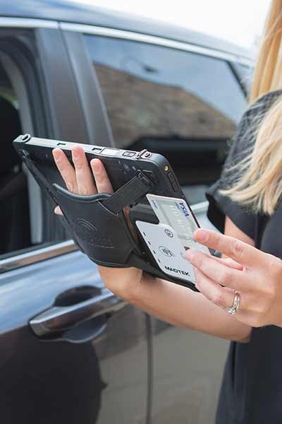 A rugged tablet being used to scan a credit card