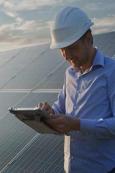 A worker uses a rugged tablet in the sunlight