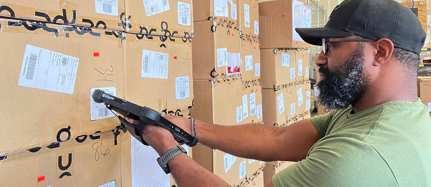 A man scans items with a rugged tablet