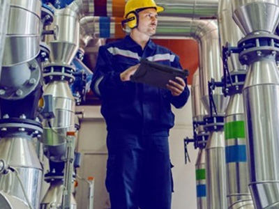 energy worker holding rugged tablet in plant