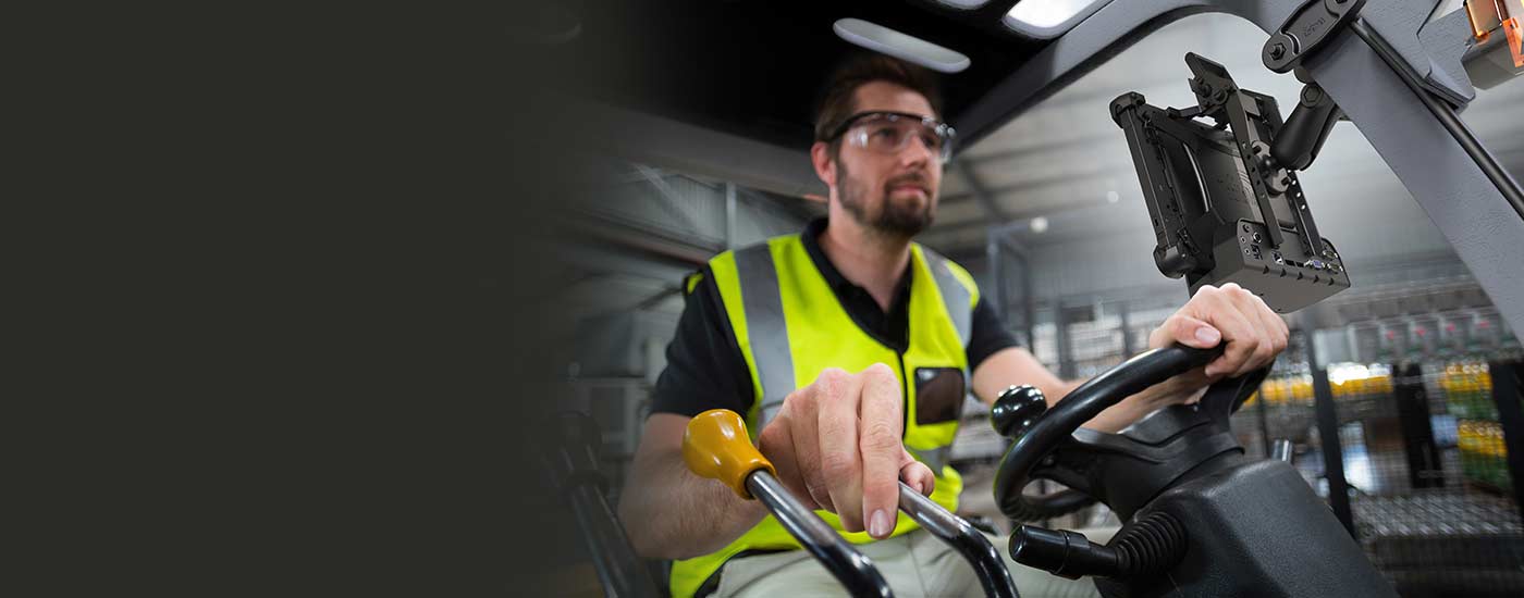 Man driving forklift with mounted rugged tablet